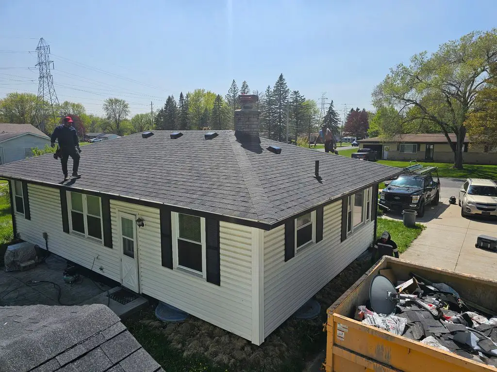 roof-inspection Hect Home Improvement worker inspecting a roof.