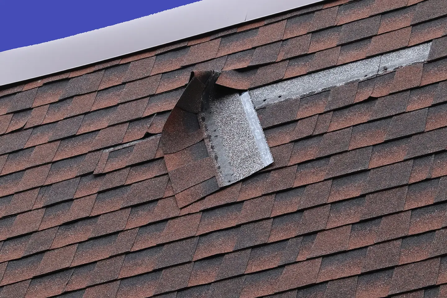 Shingle roof damage caused by a recent storm in Michigan.