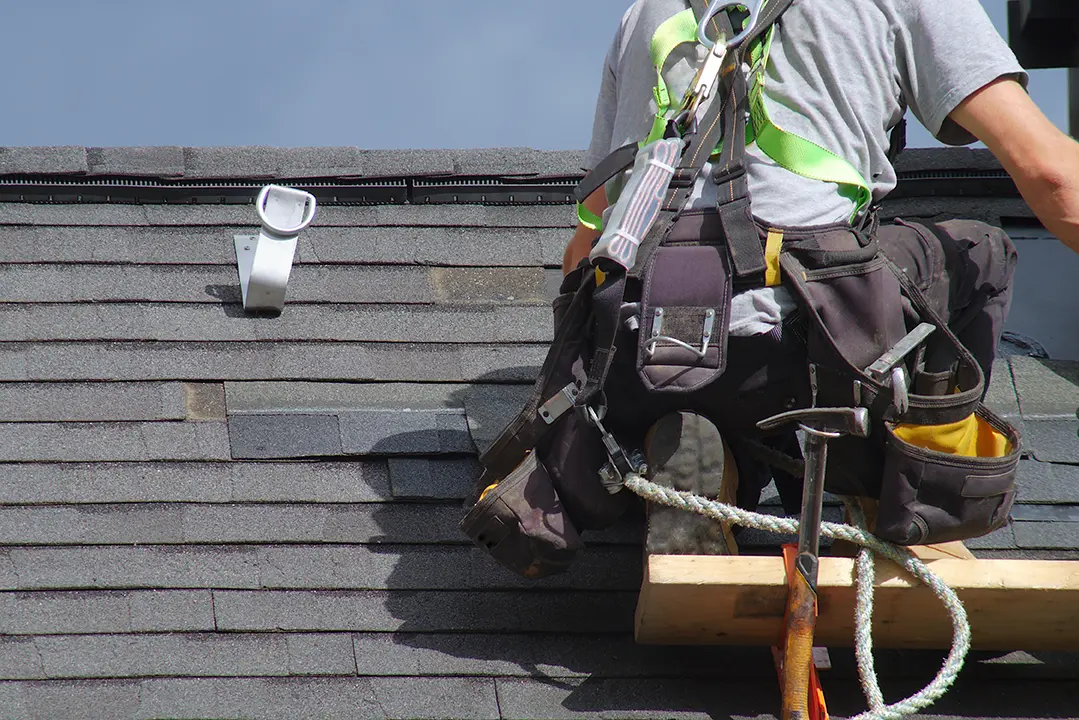 Hect Home Improvement worker reviewing some roofing work.