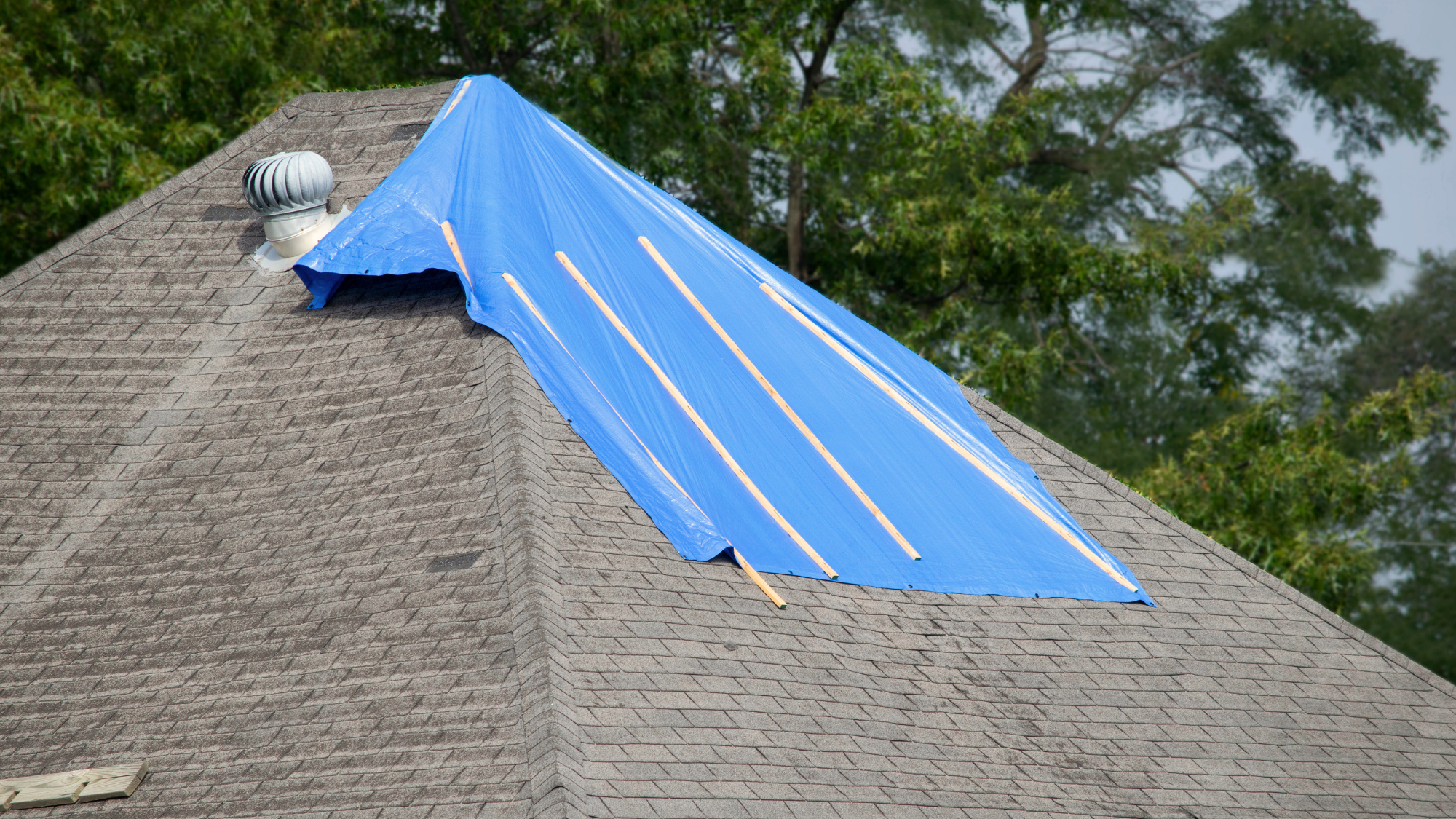 emergency tarping a roof with a leak